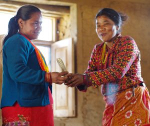 Women's group members distributing microcredit funds