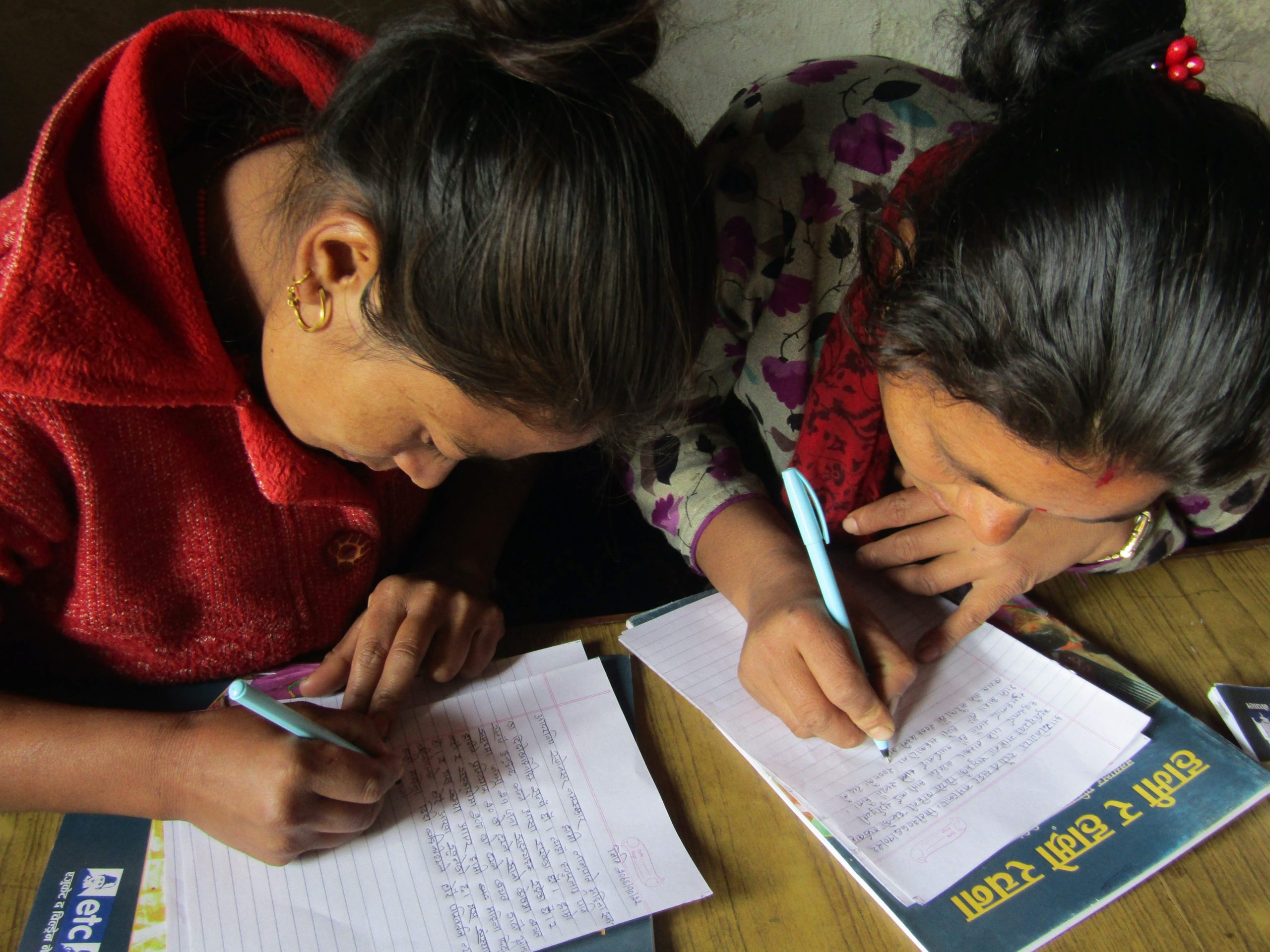 Women's group members writing